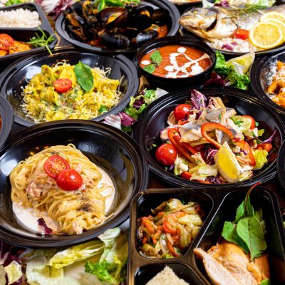 A closeup shot of a restaurant menu set on black plates - perfect food background